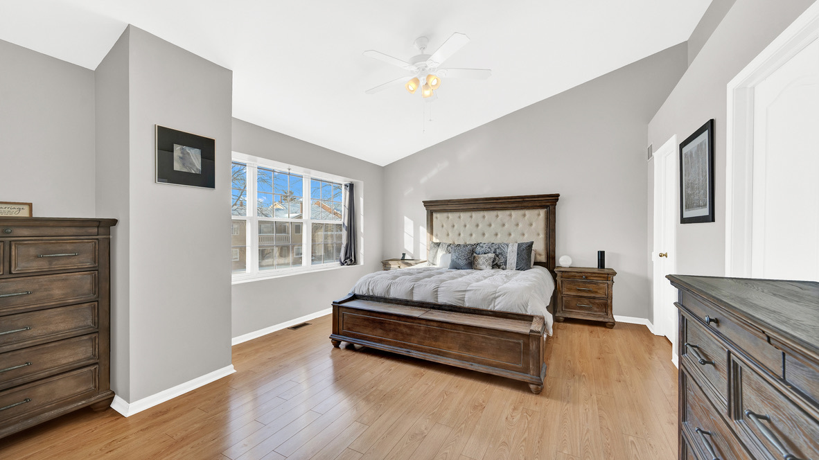 Undisclosed Address Palatine, IL 60067 - Photo 19 of 27 a spacious bedroom with a bed and wooden floor