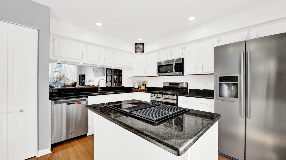 Undisclosed Address Palatine, IL 60067 - Photo 7 of 27 a kitchen with stainless steel appliances and wooden cabinets