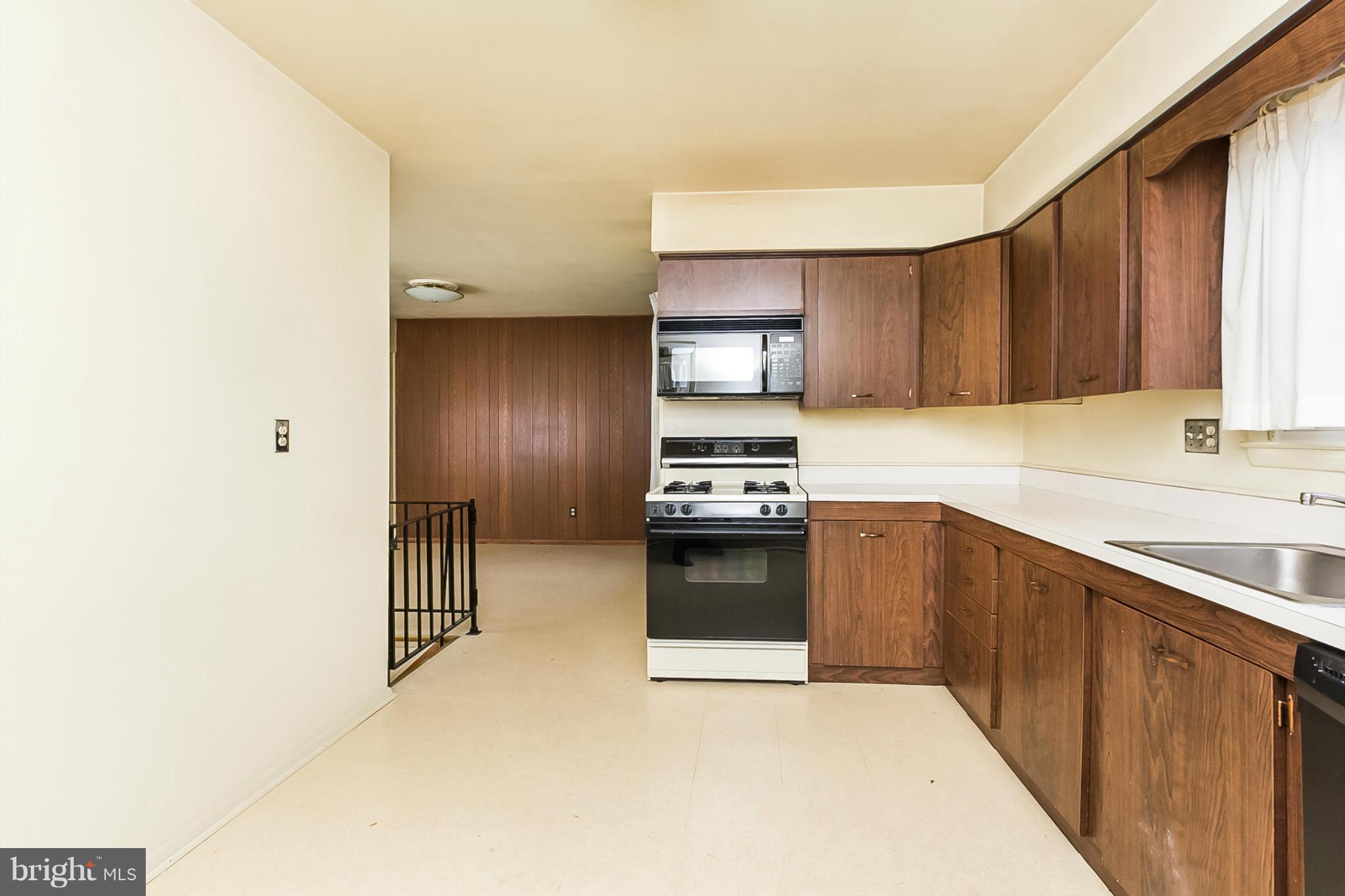 6738 Fordcrest Road Baltimore, MD 21237 - Photo 10 of 28 a kitchen with granite countertop a stove and a sink