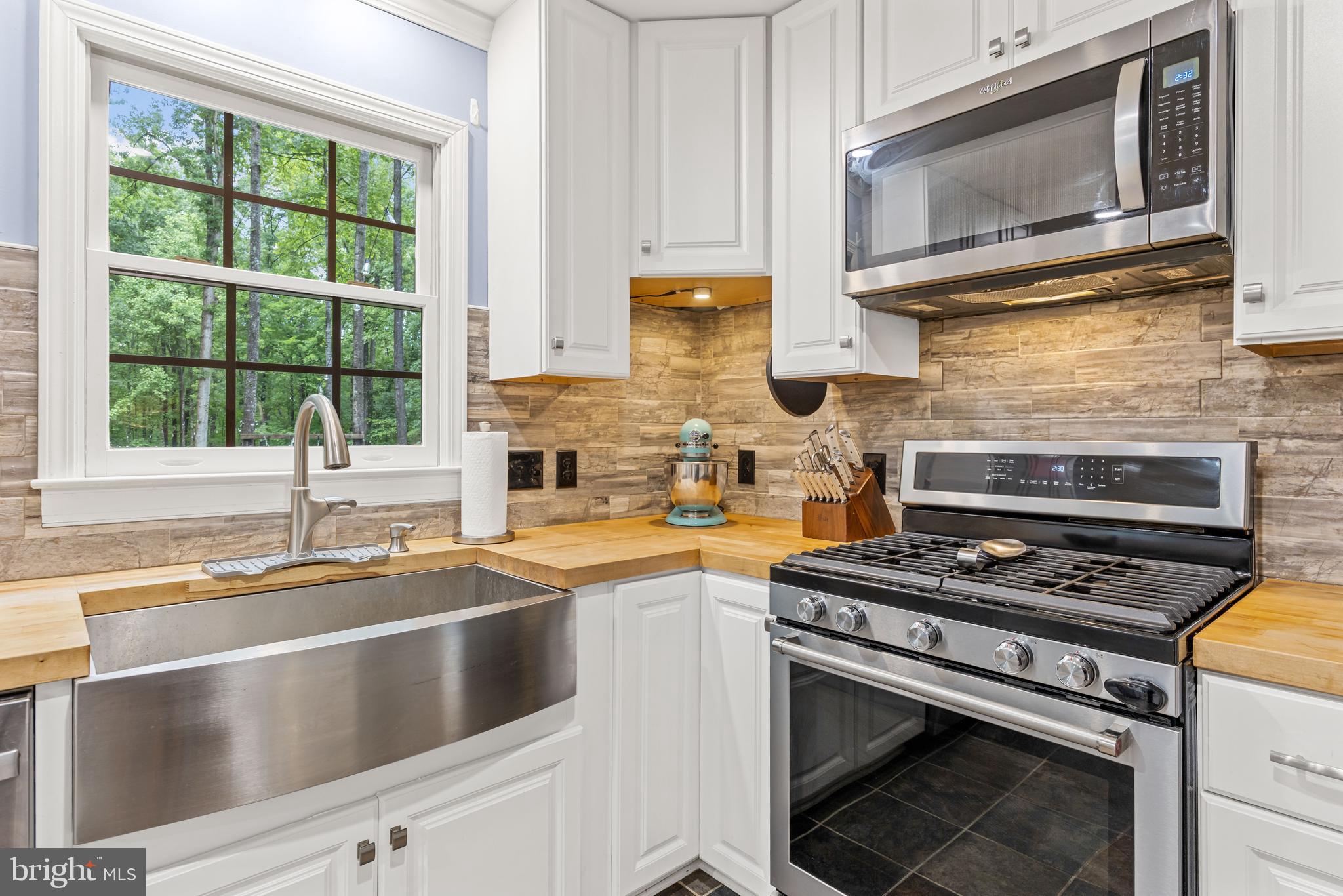 1425 Jacks Shop Road Rochelle, VA 22738 - Photo 18 of 56 a kitchen with stainless steel appliances a stove sink and microwave