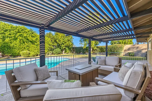 a outdoor living space with patio furniture and garden view