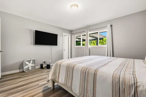 a bedroom with a bed and a flat screen tv