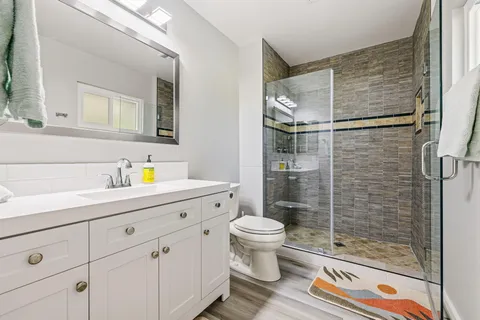 a bathroom with a shower toilet and sink