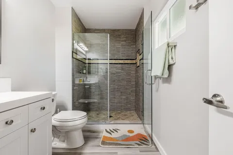 a bathroom with a toilet and a shower