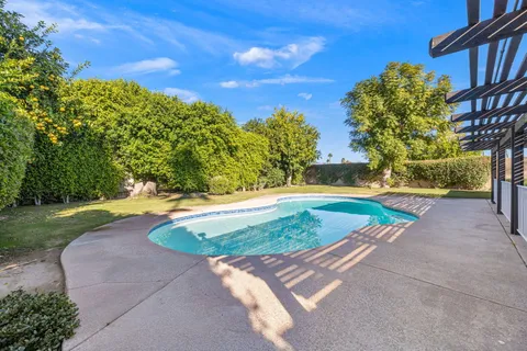a view of a swimming pool with a yard