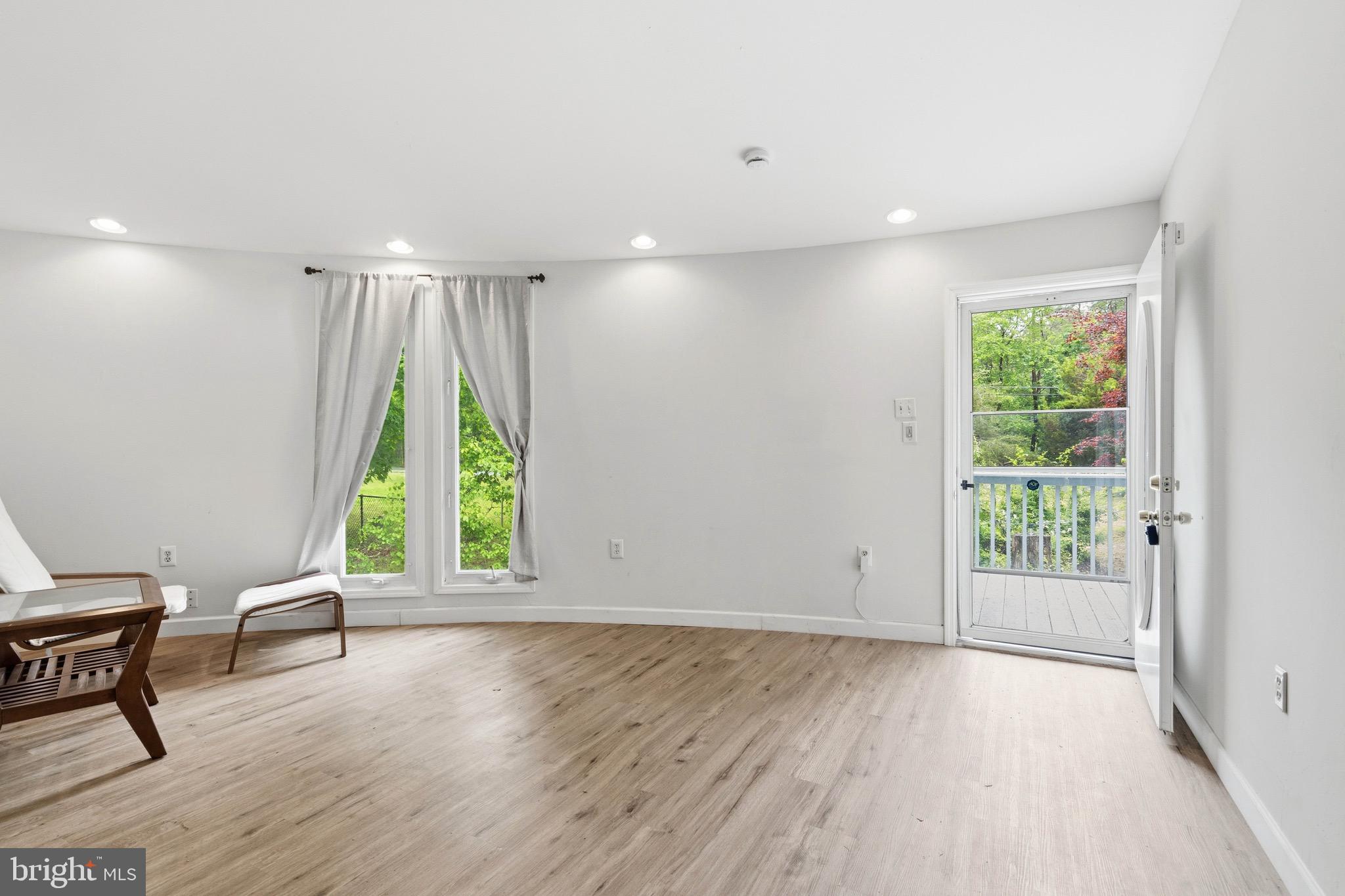 188 Carlisle Place Road Leesburg, NJ 08327 - Photo 6 of 36 a view of an empty room with a window and wooden floor