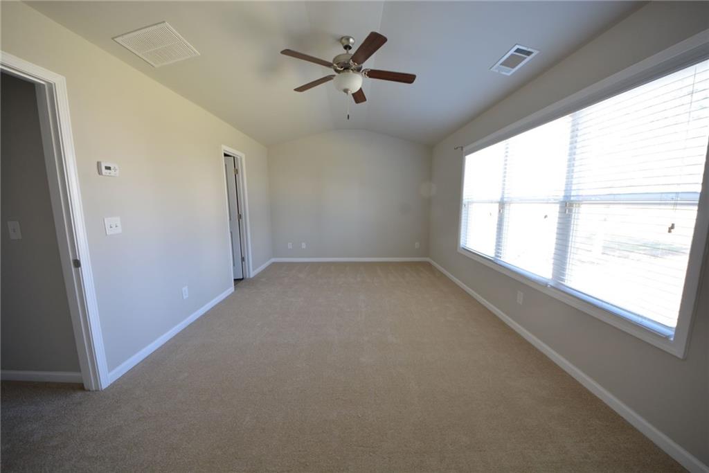 4722 Beacon Ridge Lane Flowery Branch, GA 30542 - Photo 15 of 24 an empty room with a window and a fan