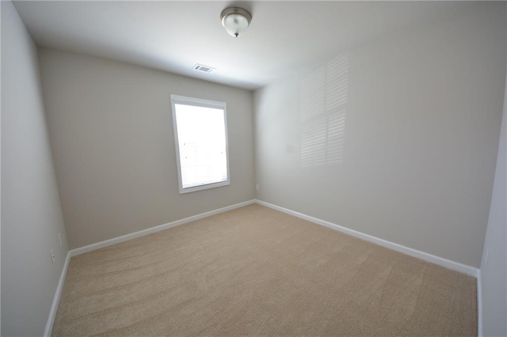 4722 Beacon Ridge Lane Flowery Branch, GA 30542 - Photo 22 of 24 an empty room with a window