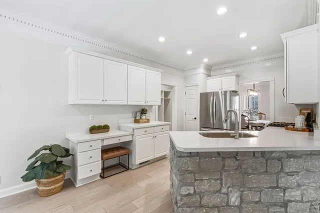 a kitchen with kitchen island granite countertop a sink counter top space and cabinets