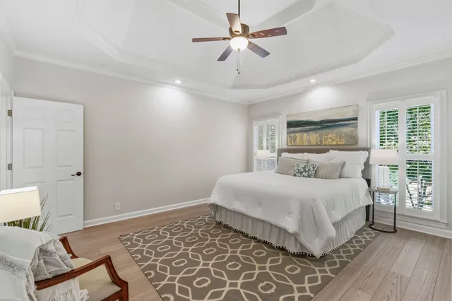 a bedroom with a large bed and a chandelier