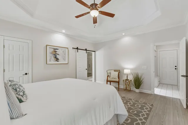a bedroom with a large bed and a chandelier