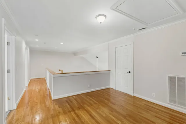 a view of a room with wooden floor