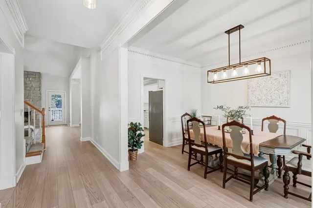 a view of a dining room with furniture and chandelier