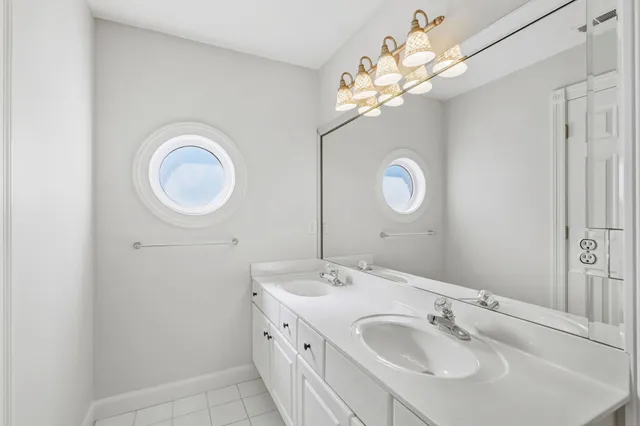 a bathroom with a double vanity sink mirror and vanity