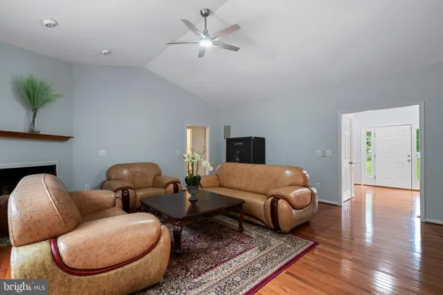 a living room with furniture ceiling fan and a rug