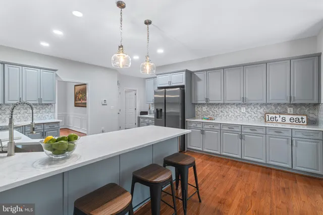 a kitchen with sink cabinets and dining table