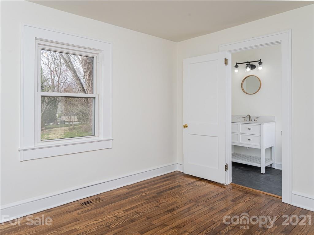 10 Souther Road, Unit 2 Fletcher, NC 28732 - Photo 12 of 38 a view of a bedroom with wooden floor and window