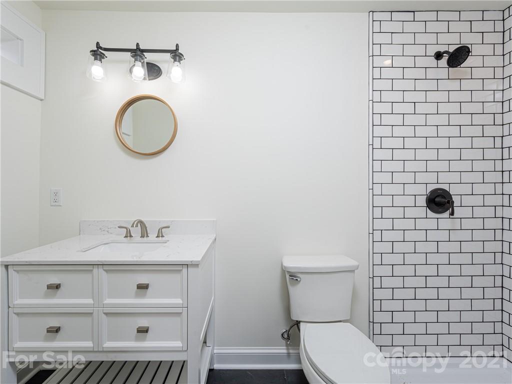 10 Souther Road, Unit 2 Fletcher, NC 28732 - Photo 13 of 38 a bathroom with a toilet a sink and a mirror