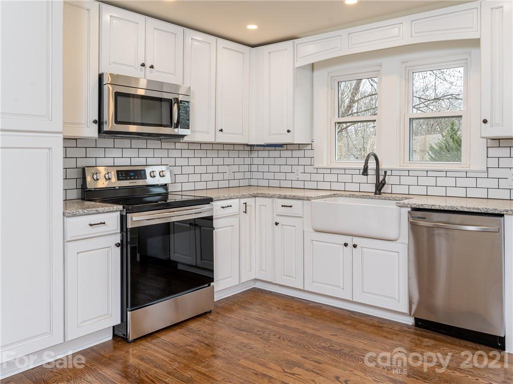 10 Souther Road, Unit 2 Fletcher, NC 28732 - Photo 19 of 38 a kitchen with white cabinets stainless steel appliances and sink