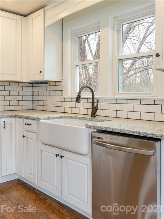 10 Souther Road, Unit 2 Fletcher, NC 28732 - Photo 21 of 38 a kitchen with stainless steel appliances granite countertop a sink a stove and white cabinets with wooden floor
