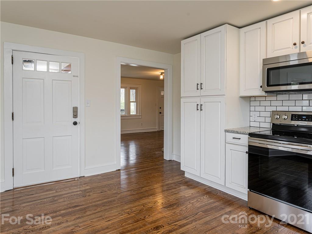10 Souther Road, Unit 2 Fletcher, NC 28732 - Photo 22 of 38 a open kitchen with white cabinets and stainless steel appliances