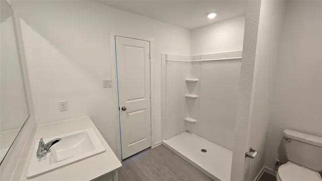 a bathroom with a sink and glass door
