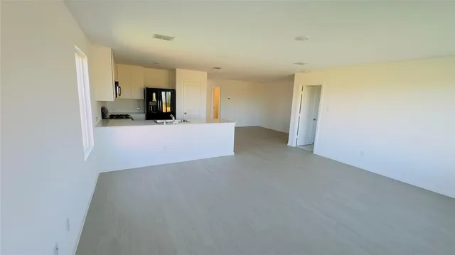 a view of a livingroom and a kitchen