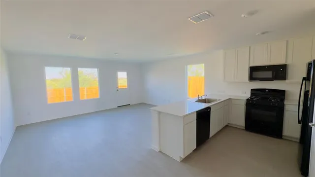 a kitchen with a refrigerator and a stove