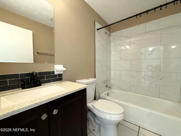 a bathroom with a sink a toilet and a bathtub