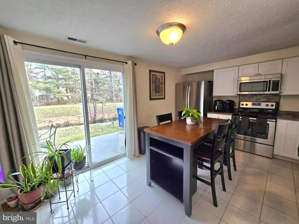 a kitchen with a table and chairs in it