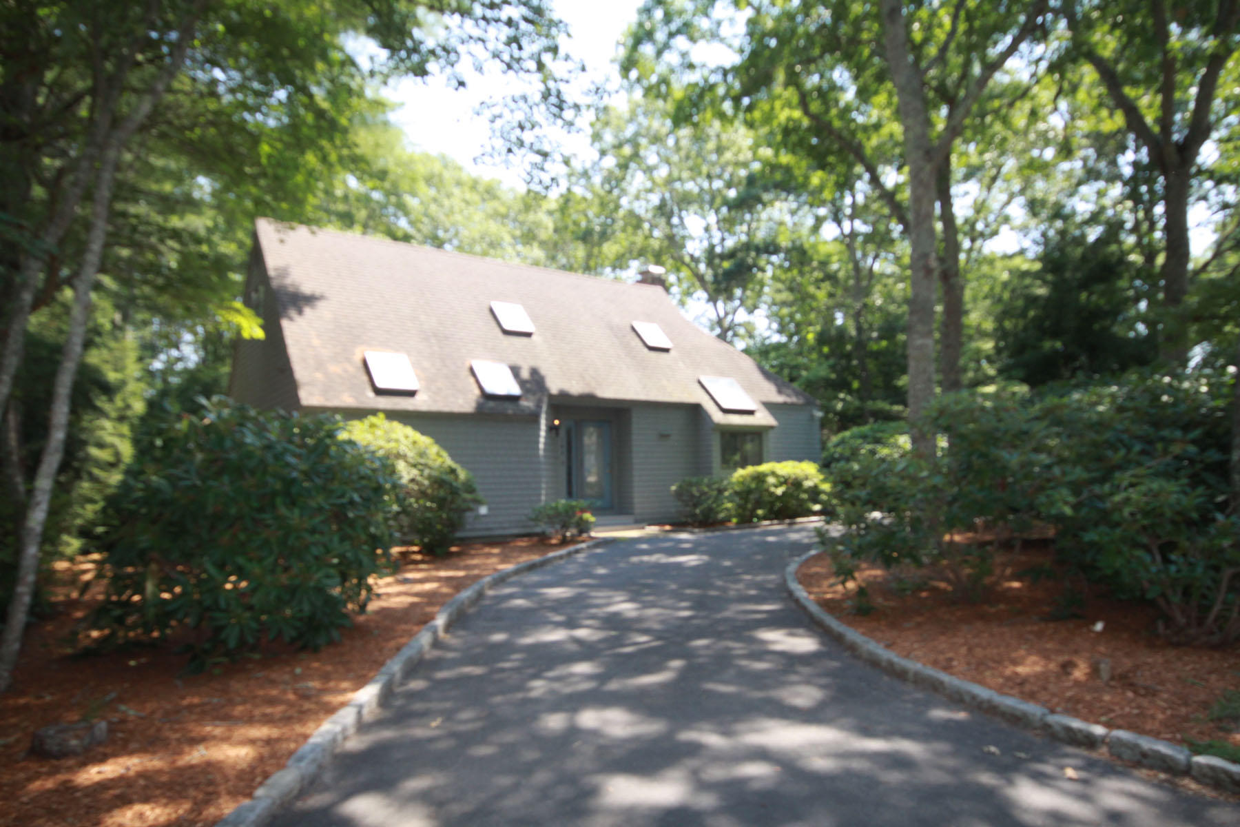 183 Fells Pond Road Mashpee, MA 02649 - Photo 1 of 19 a front view of a house with a yard and garage