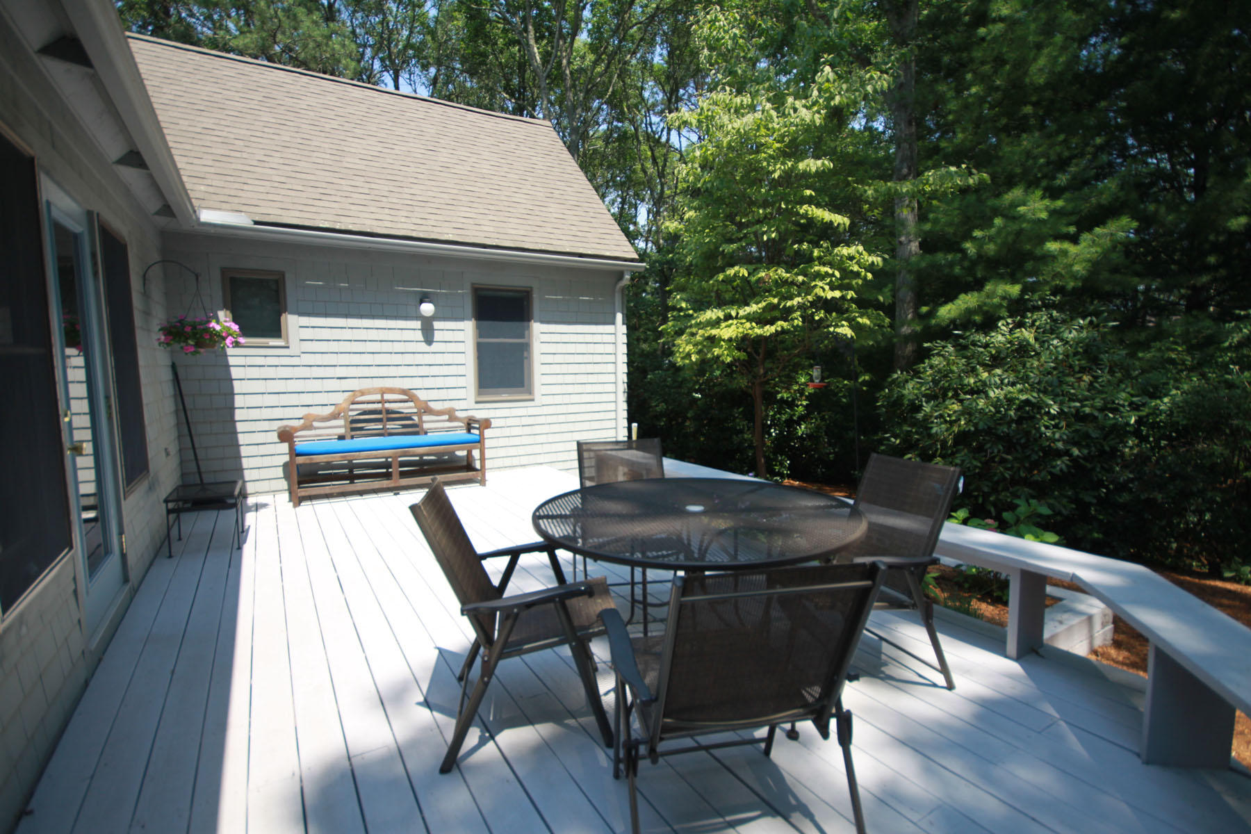 183 Fells Pond Road Mashpee, MA 02649 - Photo 19 of 19 a view of a patio with table and chairs with wooden floor and fence
