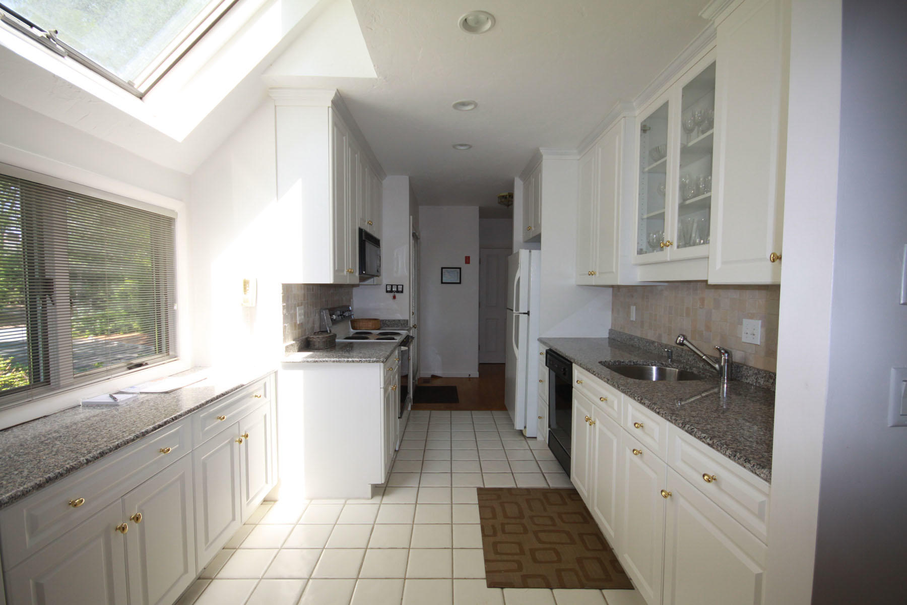 183 Fells Pond Road Mashpee, MA 02649 - Photo 2 of 19 a kitchen with a sink stove and cabinets