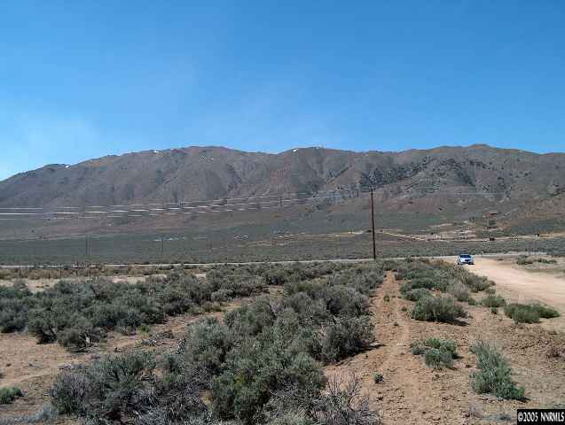 100 Silverwood Road Reno, NV 89506 - Photo 2 of 3 a view of a yard with a mountain in the background
