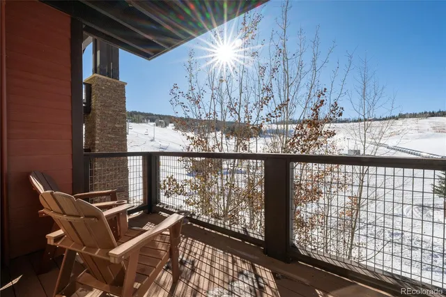 a view of a chairs and table in the balcony