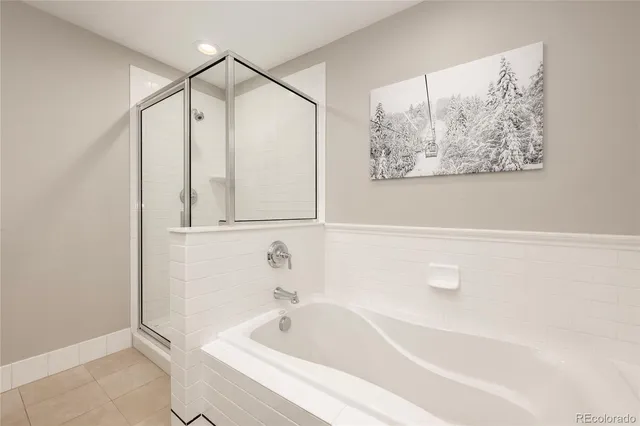 a bedroom with a bed and a large window with chair