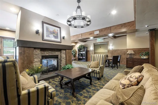 a living room with furniture a table and a fireplace