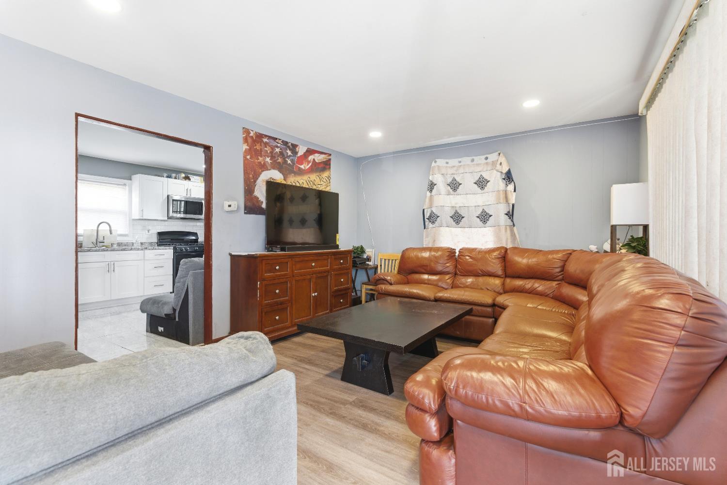 47 Spruce Street Port Reading, NJ 07064 - Photo 2 of 12 a living room with furniture and a flat screen tv