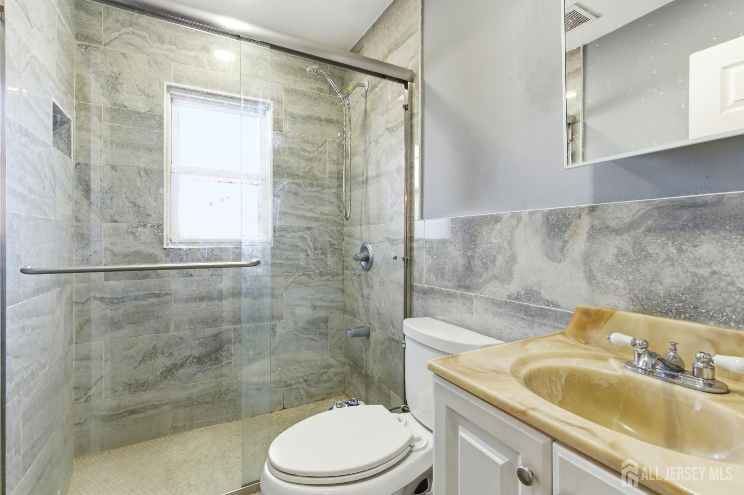 47 Spruce Street Port Reading, NJ 07064 - Photo 5 of 12 a bathroom with a sink toilet and shower