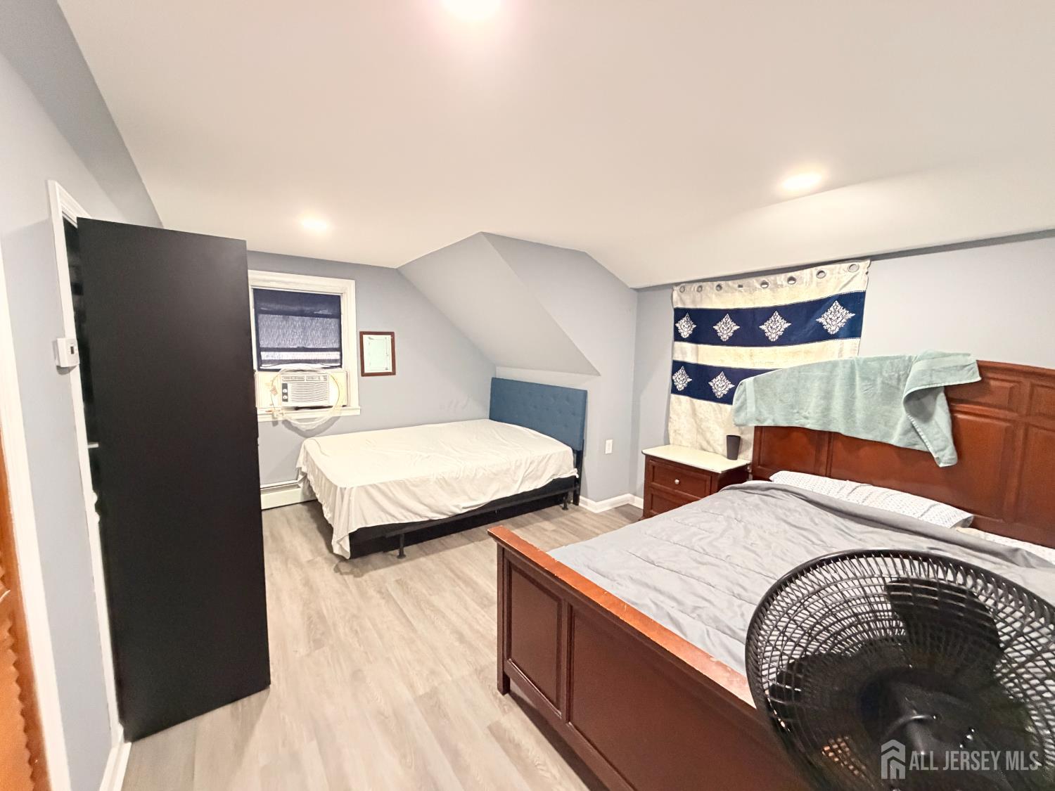 47 Spruce Street Port Reading, NJ 07064 - Photo 7 of 12 a bedroom with two beds and painting on the wall