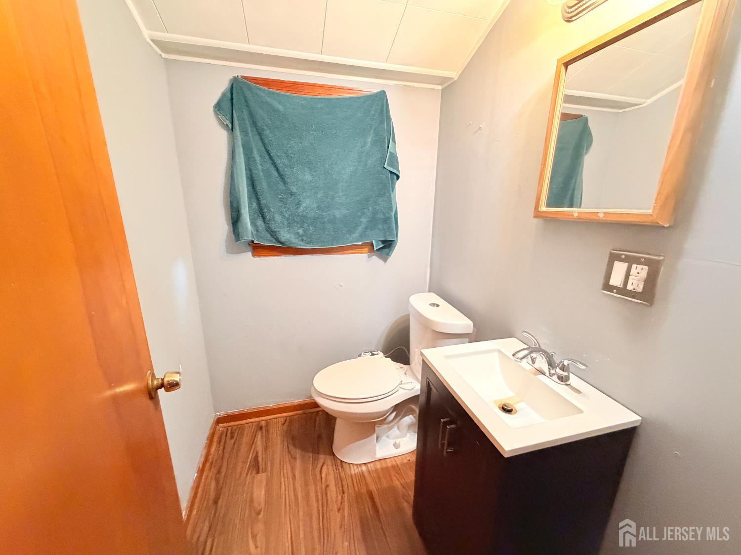 47 Spruce Street Port Reading, NJ 07064 - Photo 8 of 12 a bathroom with a toilet sink and mirror