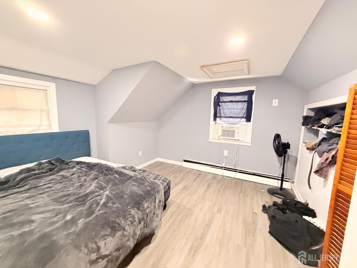 47 Spruce Street Port Reading, NJ 07064 - Photo 9 of 12 a bedroom with a bed and wooden floor