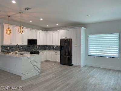3651 29th Avenue Southwest Naples, FL 34117 - Photo 2 of 8 a kitchen with stainless steel appliances granite countertop a refrigerator and a stove top oven