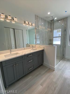 3651 29th Avenue Southwest Naples, FL 34117 - Photo 6 of 8 a bathroom with a double vanity sink mirror and double