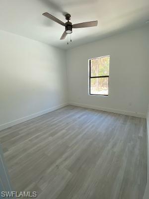 3651 29th Avenue Southwest Naples, FL 34117 - Photo 7 of 8 en empty room with windows and ceiling fan