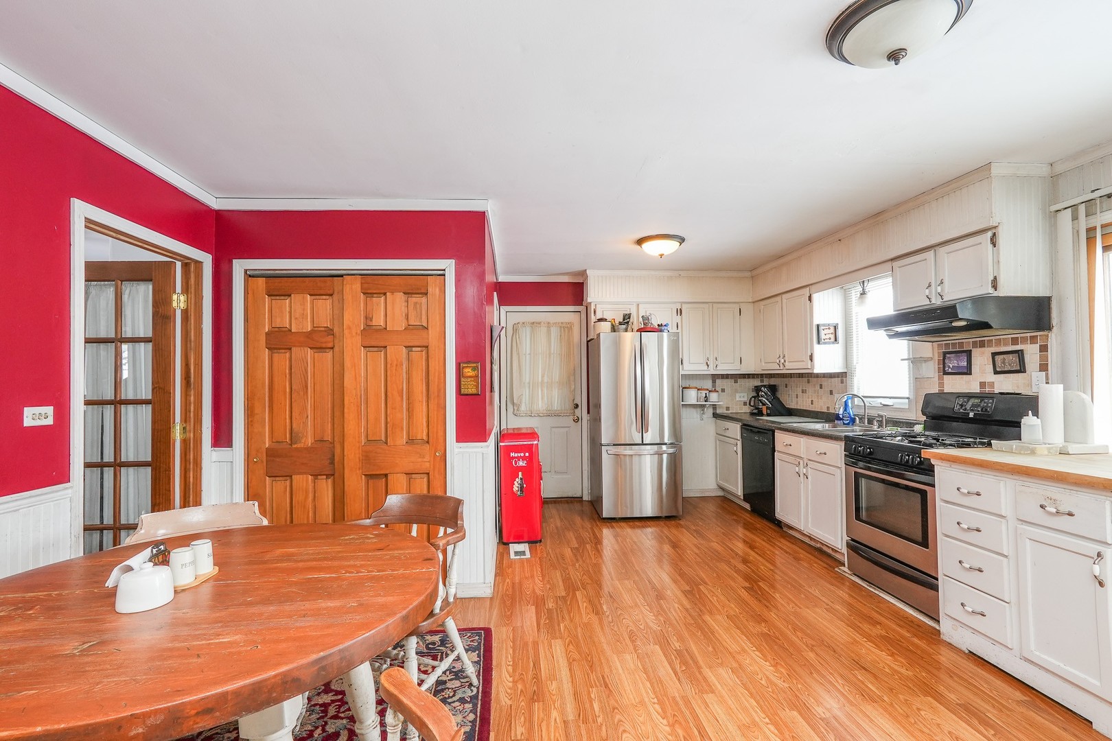 27429 South Scheer Road Manhattan, IL 60442 - Photo 14 of 21 a kitchen with stainless steel appliances granite countertop a refrigerator a stove top oven a sink dishwasher and white cabinets with wooden floor
