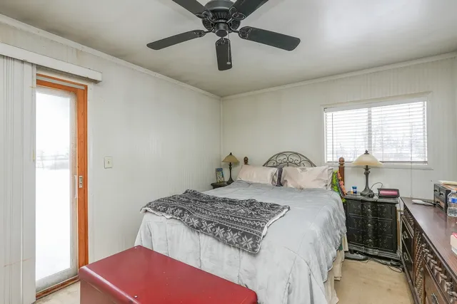 a bedroom with a bed furniture and a flat tv screen