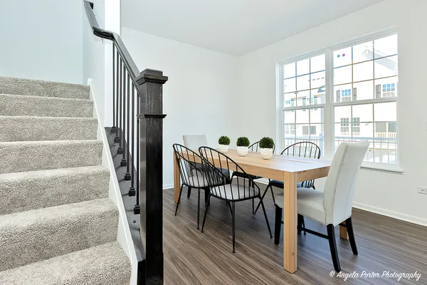a view of a dining room with furniture window and wooden floor