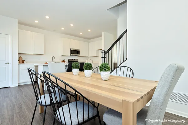 a view of a dining room with furniture and wooden floor