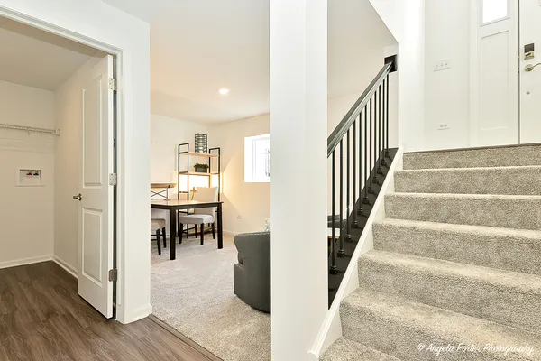 a view of a hallway with wooden floor and entryway